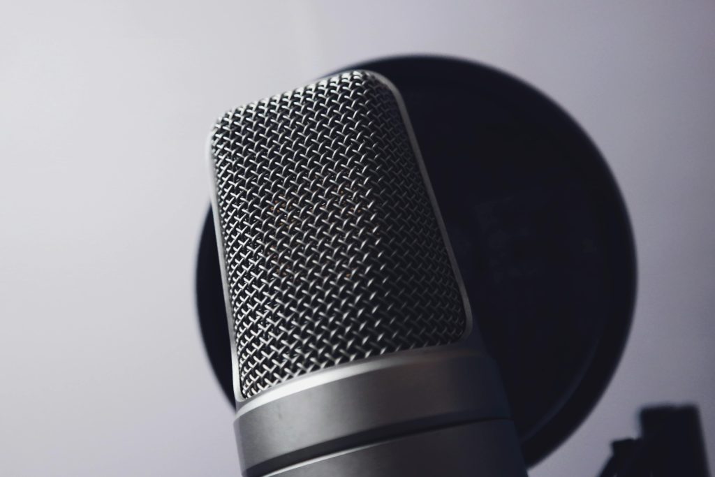 A close-up of a professional microphone in a studio. Ideal for music and broadcasting themes.
